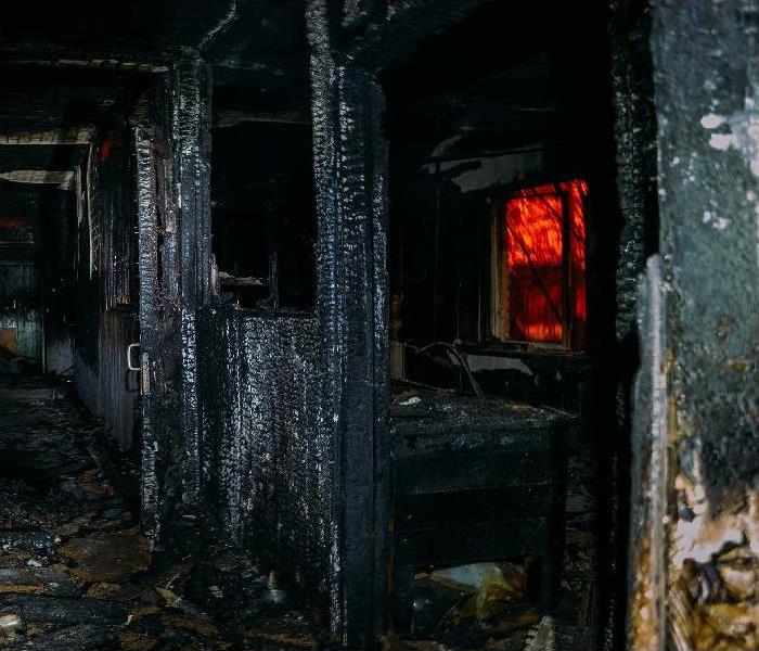 Dark burnt rural wooden house corridor after fire